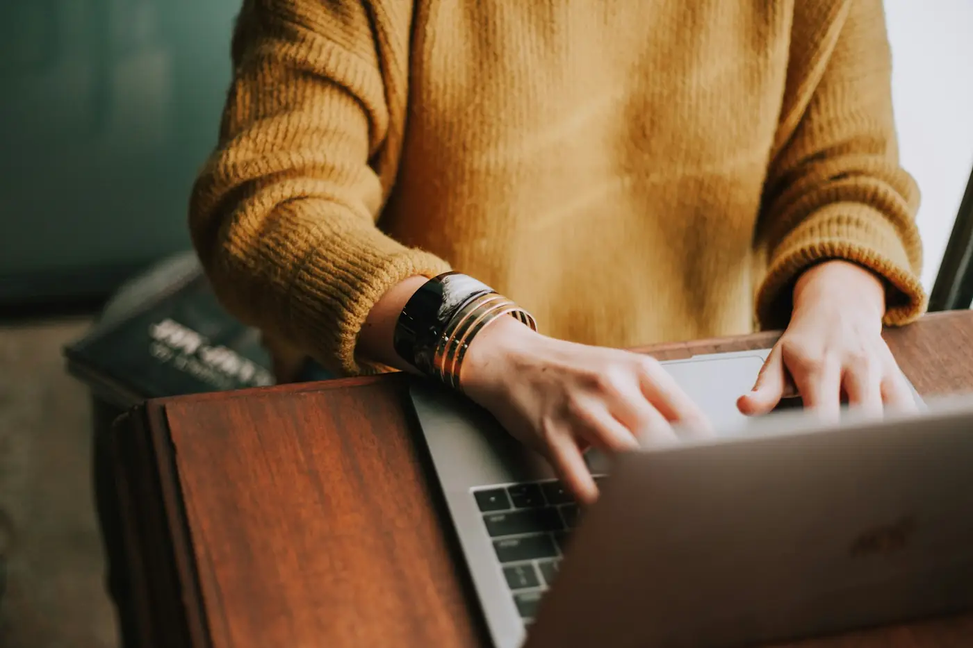 Hands typing on a laptop at a desk, the ten minutes a week a timesheet asks for