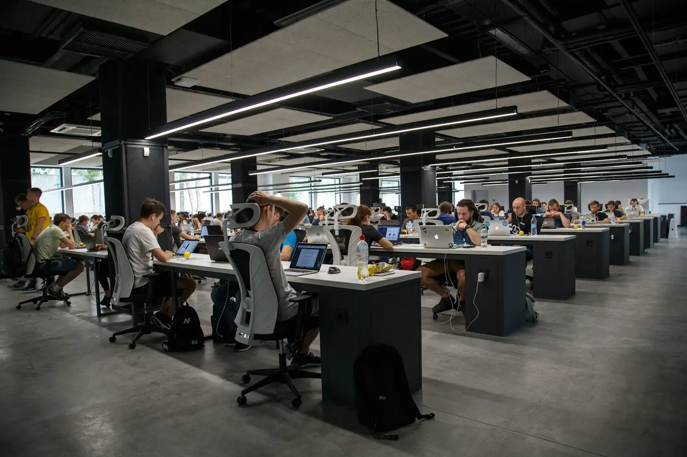Rows of desks in a large open-plan office, the scale of firm that enterprise suites are built for