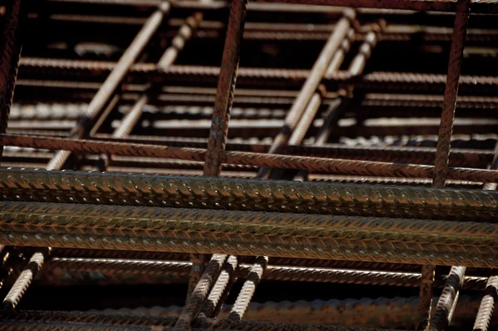 Steel reinforcement bars stacked close up, the kind of material a construction budget is mostly spent on