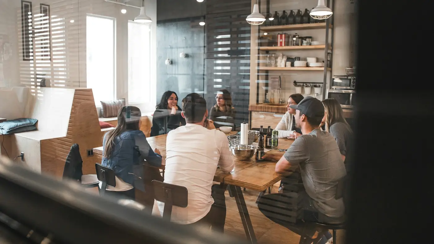 A design team meeting around a table in a studio office to review where their projects stand