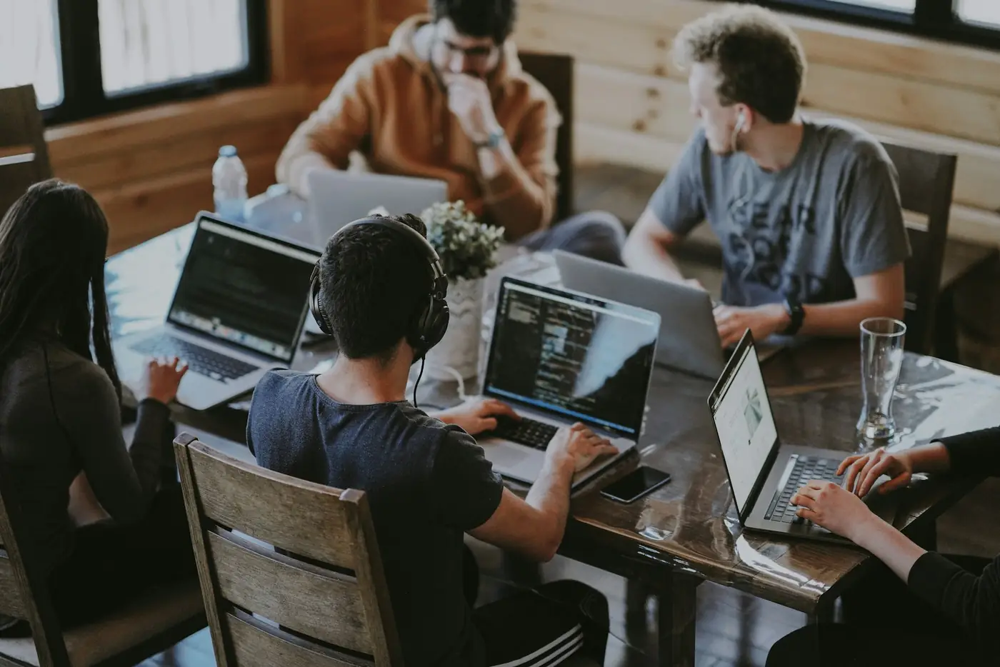 A small studio team working together on laptops, busy on several projects at once